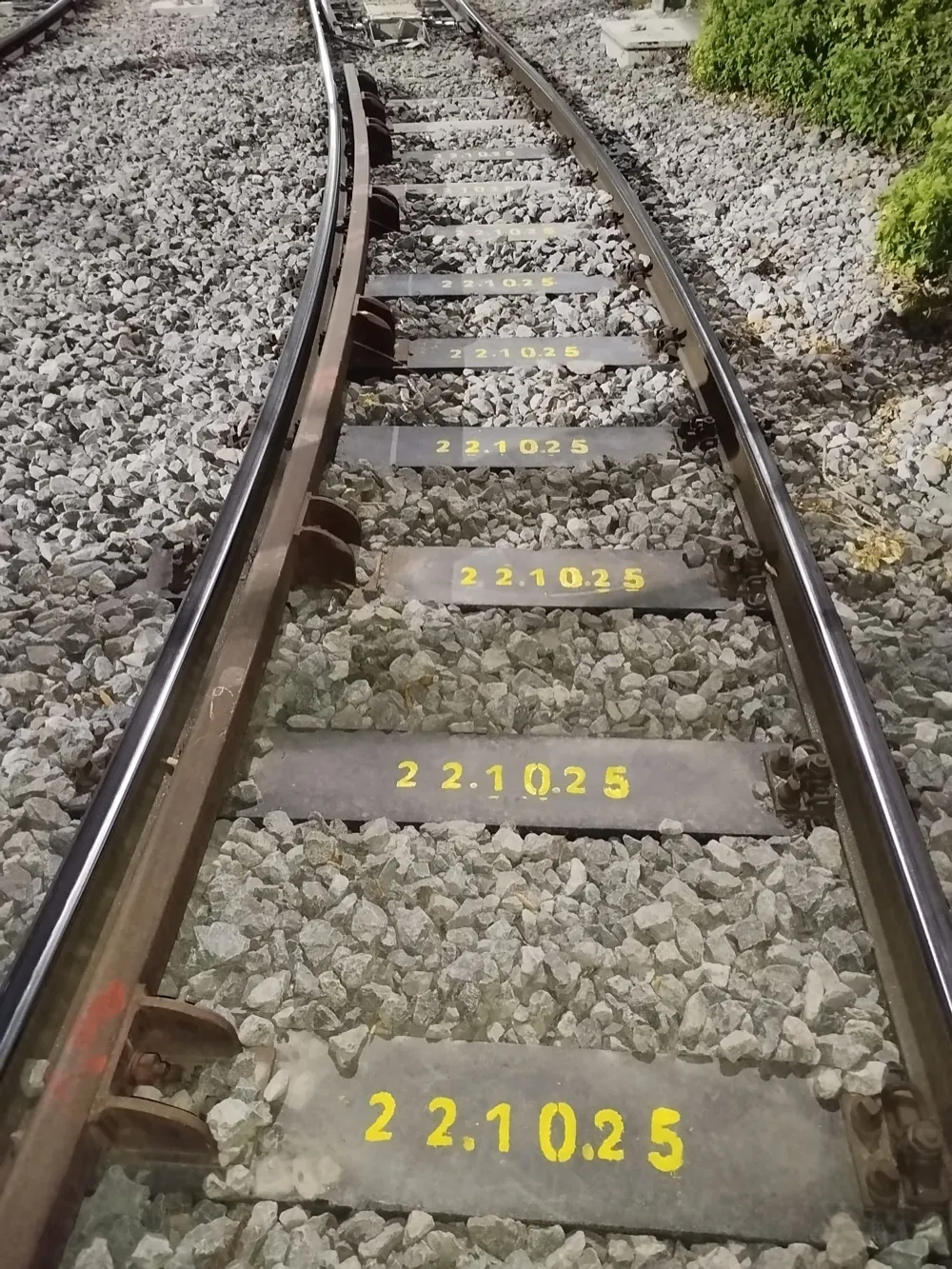 Composite sleepers on a curved track, the date 22.10.25 stencilled in yellow