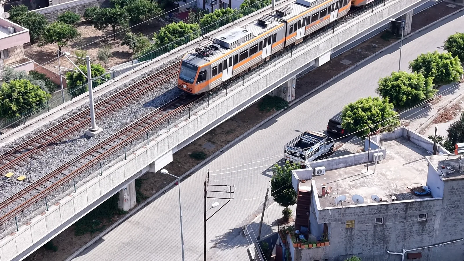 Metro set advancing on a viaduct, aerial